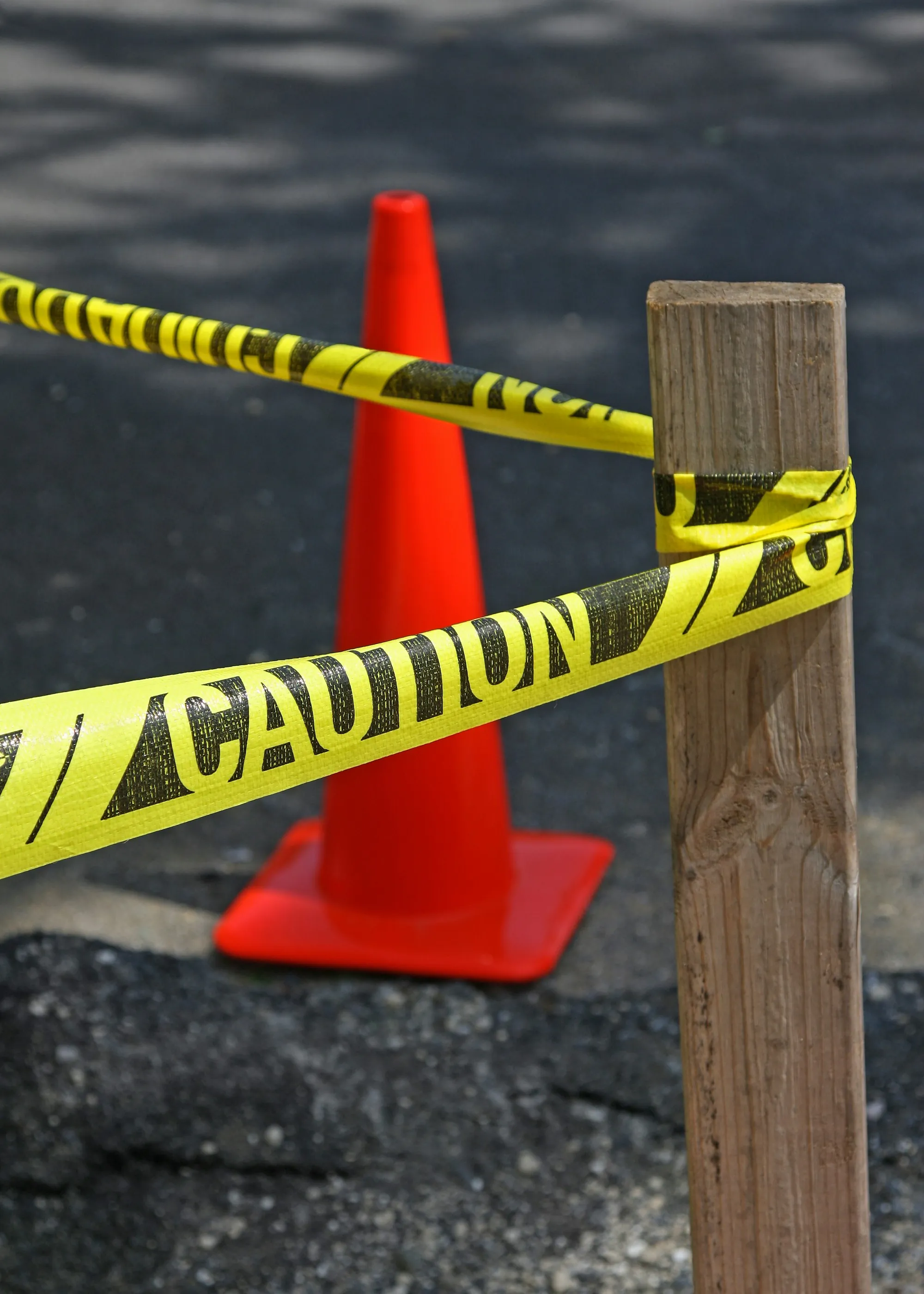 Caution tape and a traffic cone